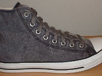 Grey Chucks  Outside view of a right distressed black high top.