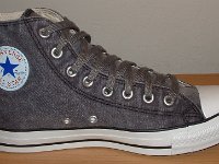 Grey Chucks  Inside patch view of a left distressed black high top.