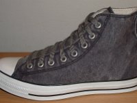 Grey Chucks  Outside view of a left distressed black high top.