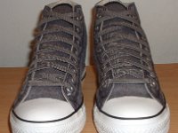 Grey Chucks  Front view of distressed black high tops.