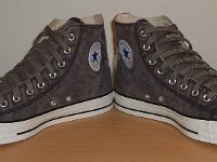 Grey Chucks  Angled front views of distressed black high tops.