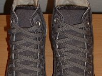 Grey Chucks  Top view of distressed black high tops.