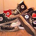 Group Shots of Chucks  Pile of worn Chuck Taylor high tops, including the core colors of black, white, blue, and red.