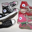 Group Shots of Chucks  Four pairs of high top chucks: black, black/pink 2-tone, red, and neon pink/green All Star print.
