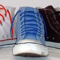Group Shots of Chucks  Optical white, huckleberry blue, and chocolate brown high tops with narrow laces.