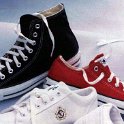 Group Shots of Chucks  Black high top and red low cut chuck with white leather tennis shoes.