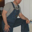 Guys Wearing Black Chucks  Guy wearing black high top chucks with a grey tee shirt and blue jean overalls.