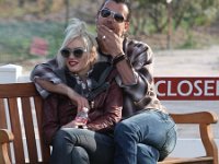 Gwen Stefani  Gwen seated on a bench with her husband, Gavin Rossdale. : paparazzi