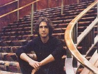 Josh Groban  Seated on a staircase.