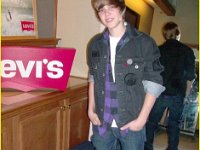 Justin Bieber  Justin Bieber posing in purple and black monochrome high top chucks.