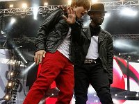 Justin Bieber  Justin Bieber talking with a rapper wearing black high top chucks.