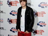 Justin Bieber  Justin Bieber wearing black high top chucks at a photo session.