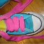 Knee High Chucks  Top view of a light blue and yellow right knee high with wide pink laces.