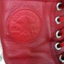 Knee High Chucks  Closeup of the inside patch on a red monochrome leather knee high.