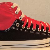 Layer Up High-Low Chucks  Outside view of a right black and red layer up high top with red and white shoelaces.