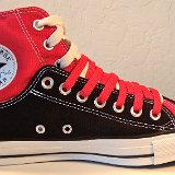 Layer Up High-Low Chucks  Inside patch view of a left black and red layer up high top with red and white shoelaces.