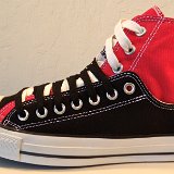 Layer Up High-Low Chucks  Outside view of a left black and red layer up high top with black and white shoelaces.