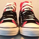 Layer Up High-Low Chucks  Front view of black and red layer up high tops with black and white shoelaces.