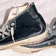 Leather Chucks  Worn black leather high tops, side views.
