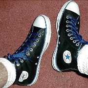Leather Chucks  Wearing black leather high tops with blue piping and laces, angled top view.