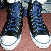 Leather Chucks  Black leather high tops with blue piping and laces, front view.