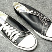 Leather Chucks  Black leather low cuts with irregular leather sides, top view.