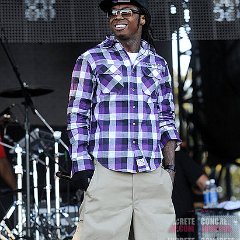 Lil Wayne  Lil Wayne wearing purple high top chucks on stage.