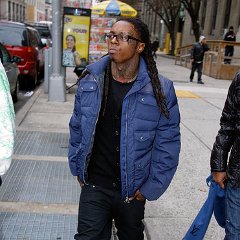 Lil Wayne  Lil Wayne in black chucks while walking the street.