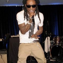 Lil Wayne  Lil Wayne performing in new with tag black low top chucks.