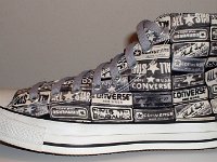 Chucks With Repeated Logo Pattern Uppers  Outside view of a left black and white heel patch print high top with gray shoelaces.