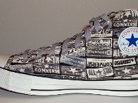 Chucks With Repeated Logo Pattern Uppers  Inside patch view of a right black and white heel patch print high top with gray shoelaces.