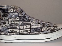 Chucks With Repeated Logo Pattern Uppers  Outside view of a right black and white heel patch print high top with gray shoelaces.