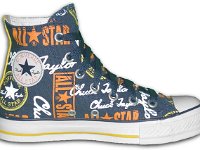 Chucks With Repeated Logo Pattern Uppers  Inside patch view of a left blue, yellow, white and gold logo print high top with blue laces.