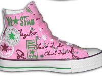 Chucks With Repeated Logo Pattern Uppers  Inside patch view of a left pink, green, maroon and white logo print high top with pink shoelaces.