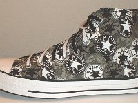 Chucks With Repeated Logo Pattern Uppers  Outside view of a left black and white repeat ankle patch print high top with black and white reversible shoelaces.