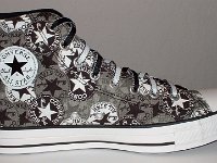 Chucks With Repeated Logo Pattern Uppers  Inside patch view of a left black and white repeat ankle patch print high top with black and white reversible shoelaces.