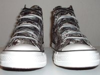 Chucks With Repeated Logo Pattern Uppers  Front view of black and white repeat ankle patch print high tops with black and white reversible shoelaces.