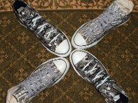 Chucks With Repeated Logo Pattern Uppers  Top view of a wheel of black and white Chuck Taylor logo patch print high tops.