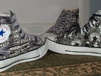 Chucks With Repeated Logo Pattern Uppers  Side view of a wheel of black and white Chuck Taylor logo patch print high tops