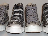 Chucks With Repeated Logo Pattern Uppers  Front view of two different pairs of black and white Chuck Taylor logo patch print high tops.