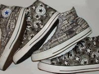 Chucks With Repeated Logo Pattern Uppers  Side view of two different pairs of black and white Chuck Taylor logo patch print high tops.