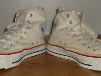 Mark Recob Vintage Chucks Collection  Angled front view of white weighted blue toe vintage Chuck Taylor All Star high tops.