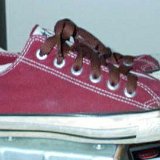 Maroon Low Cut Chucks  Worn maroon low cuts with brown laces, side view.
