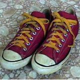 Maroon Low Cut Chucks  Worn maroon low cuts, with gold laces, angled top view.