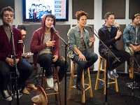 Midnight Red  Band members seated on stools and singing.