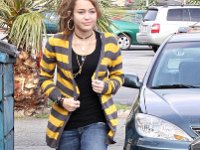 Miley Cyrus  Miley wearing plaid print chucks with yellow shoelaces.
