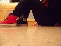 Mismatched Pairs of Chucks  Mismatched red and black high tops.