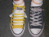 Mismatched Pairs of Chucks  Mismatched yellow and black low cut chucks.