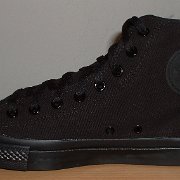 Monochrome Black Chucks  New left black monochrome high top, made in China, outside view.