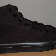 Monochrome Black Chucks  New right monochrome black high top made in China, outside view.